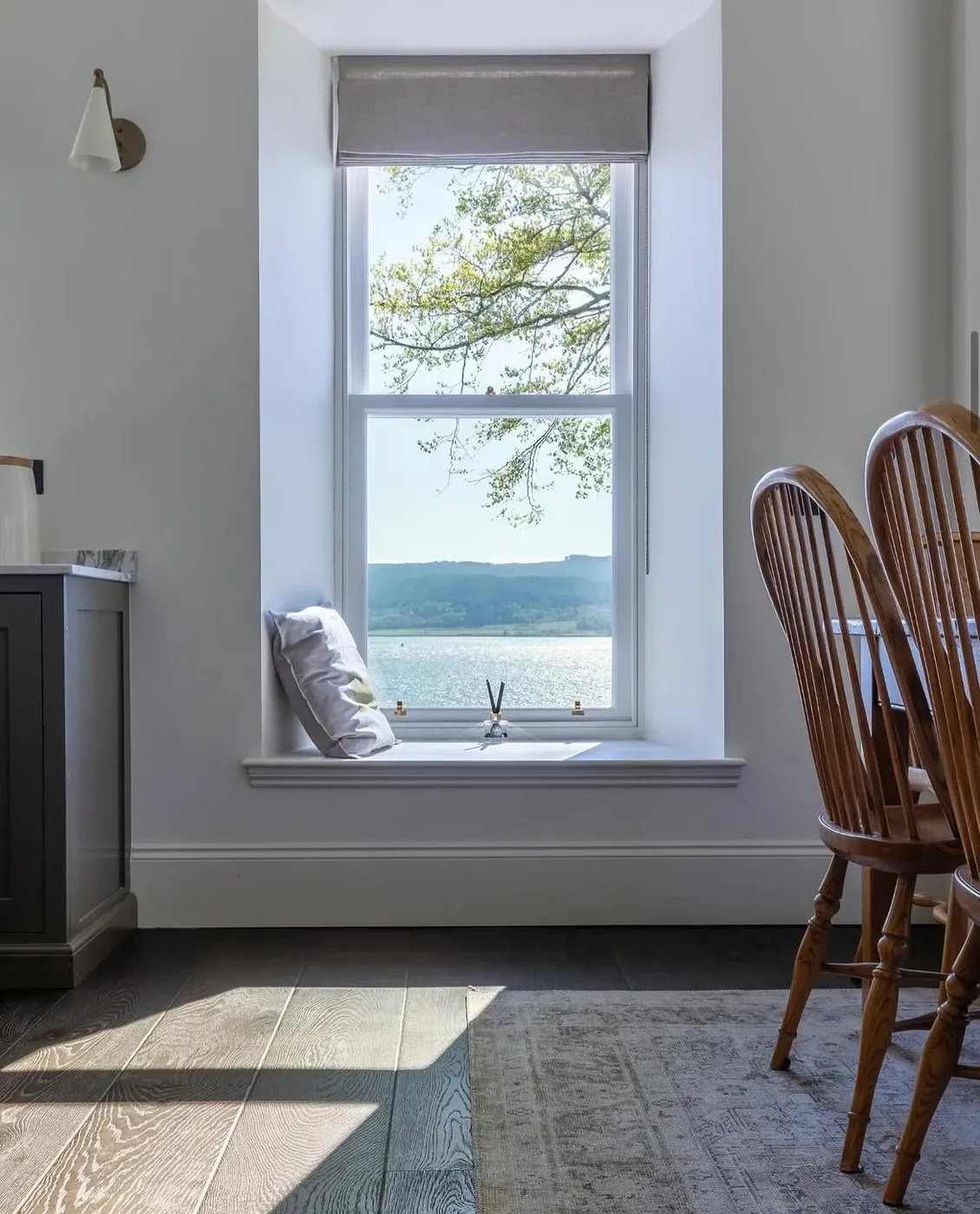 Window seat with cushions and a view across the loch